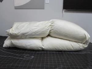 二つに折りたたまれた白い羽毛布団